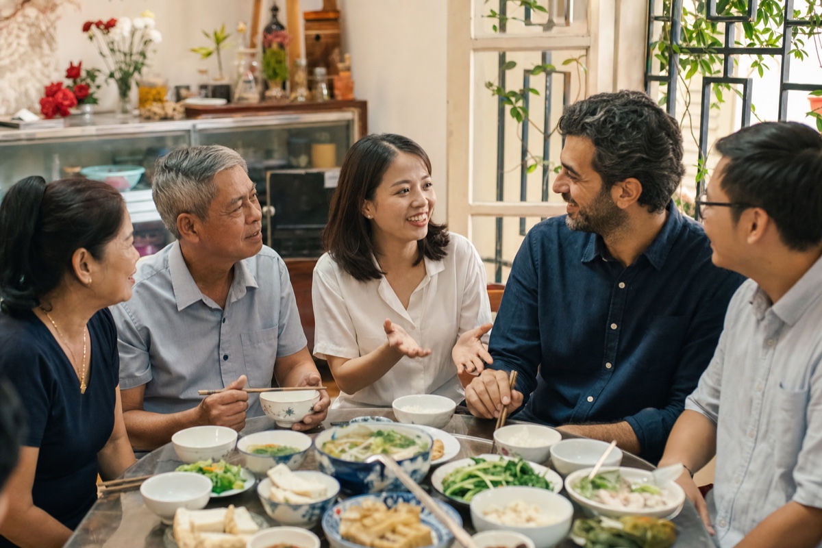 A Vietnamese woman introducing her foreign partner to family over a relaxed lunch